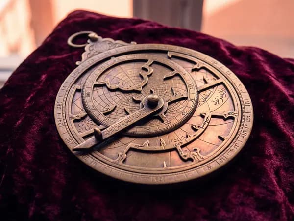 An antique astrolabe on dark velvet